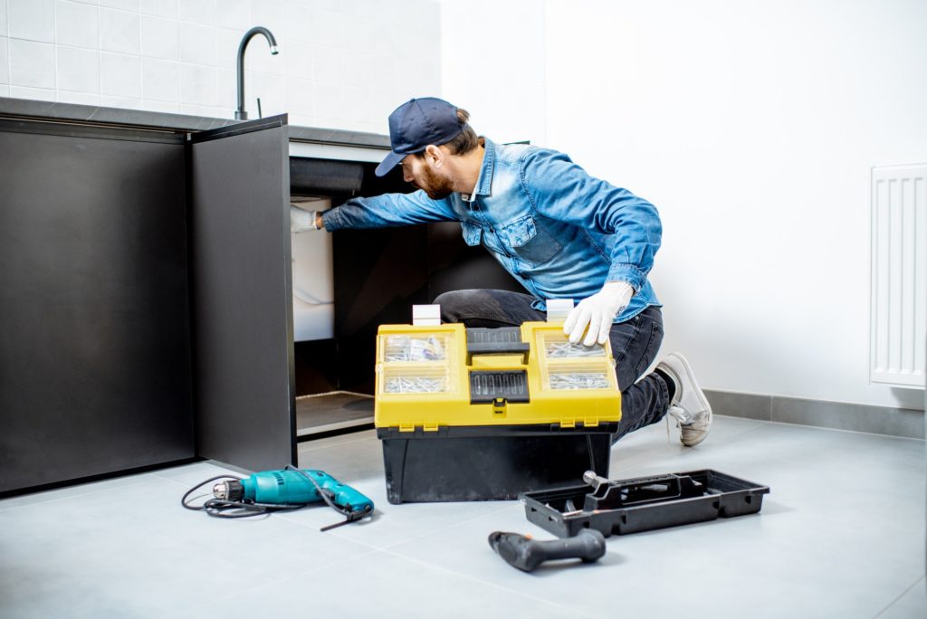 Man repairing kitchen furniture